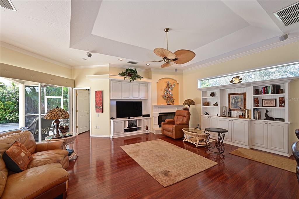 6602 Tallmast Circle Lakewood Ranch, FL 34202 - Photo 17 of 43 a living room with furniture a flat screen tv and a floor to ceiling window