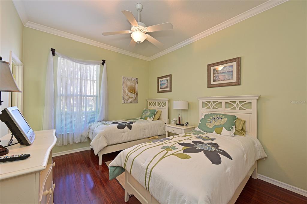 6602 Tallmast Circle Lakewood Ranch, FL 34202 - Photo 23 of 43 a bedroom with a bed and wooden floor