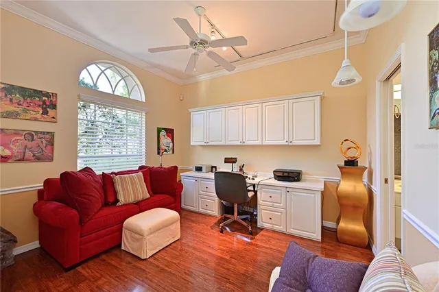 a livingroom with workspace couch and a window