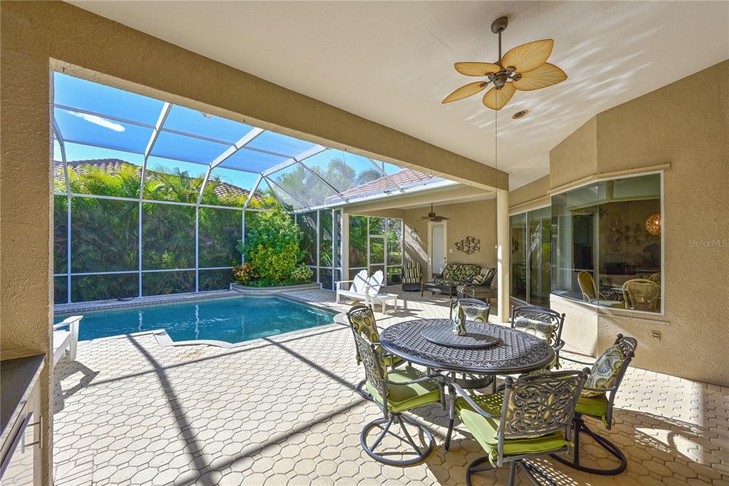 6602 Tallmast Circle Lakewood Ranch, FL 34202 - Photo 29 of 43 a view of a patio with a dining table and chairs