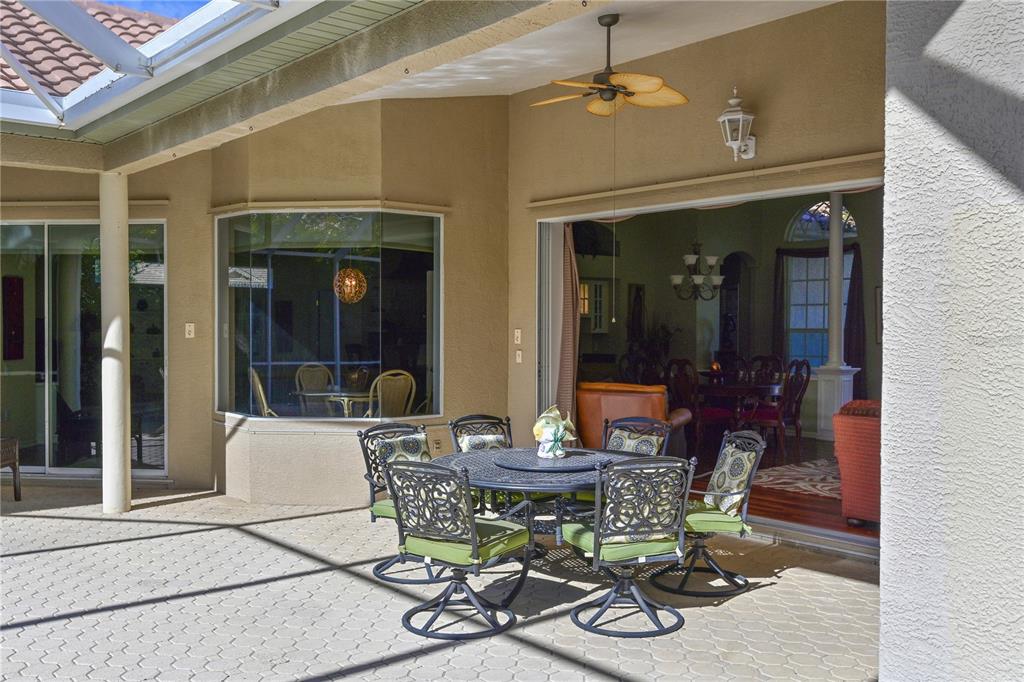 6602 Tallmast Circle Lakewood Ranch, FL 34202 - Photo 32 of 43 a view of a dining room with furniture and chandelier