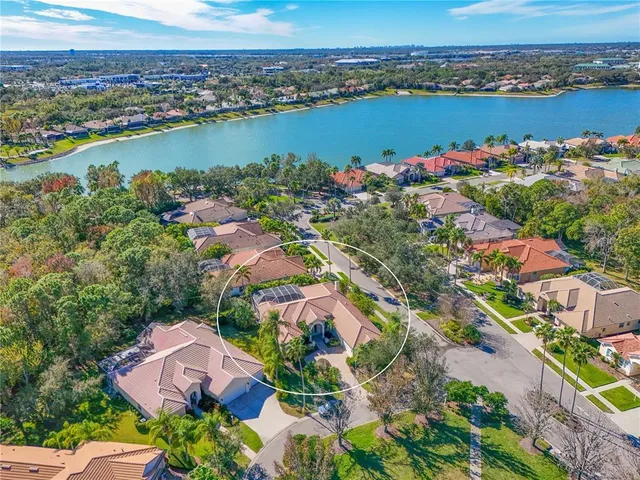 an aerial view of residential houses with outdoor space and river