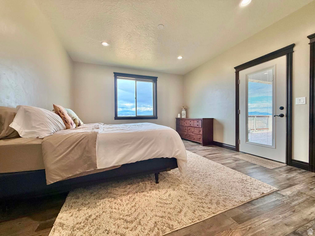 2101 Goose Ranch Road Vernal, UT 84078 - Photo 24 of 72 Bedroom featuring wood-finish flooring, recessed lighting, and a window with dark trim