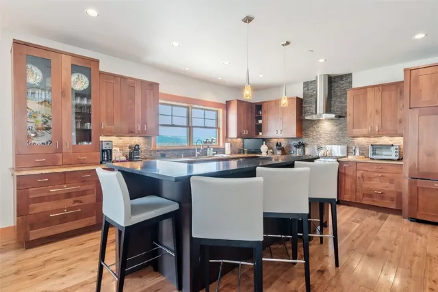 a kitchen with a table chairs refrigerator and cabinets