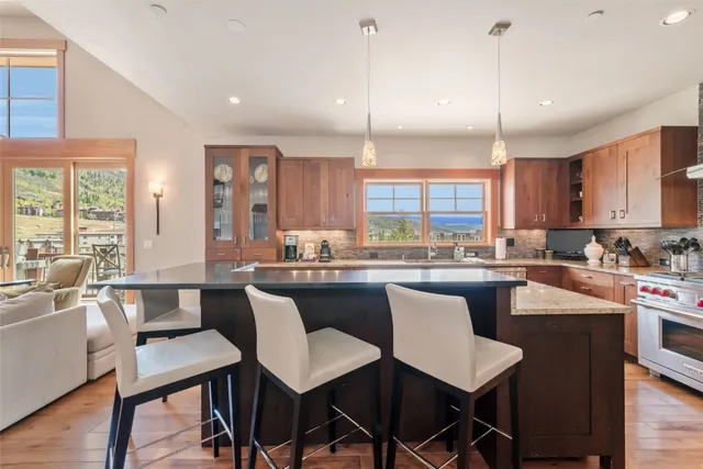 a large kitchen with a table and chairs