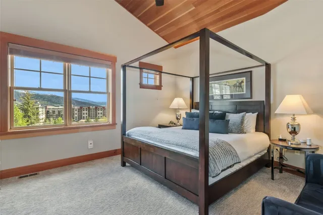 a bedroom with a bed lamp and window