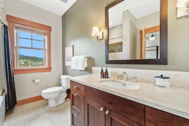a bathroom with a sink toilet and a mirror