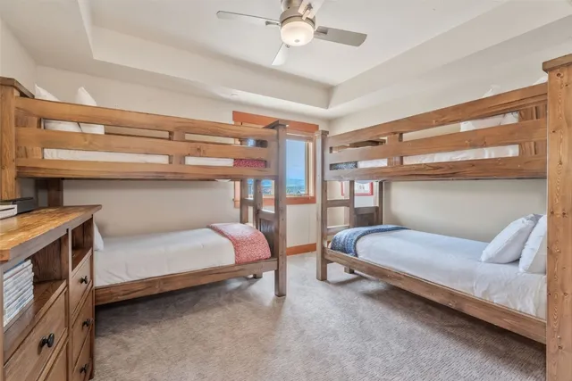 a bedroom with a bed and a ceiling fan