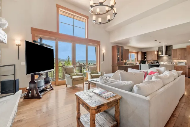 a living room with furniture a flat screen tv and a large window