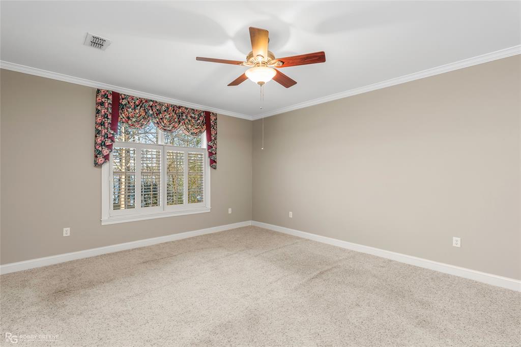 703 Airport Loop Homer, LA 71040 - Photo 14 of 32 an empty room with window and ceiling fan