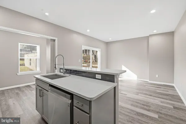 a kitchen with granite countertop a sink a stove and microwave