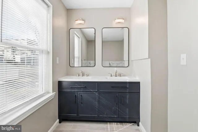 a bathroom with a tub sink and window