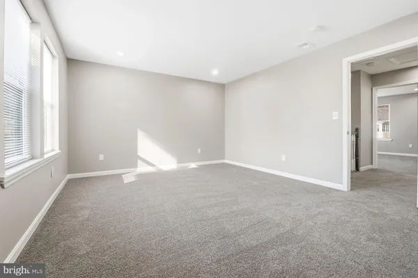 an empty room with windows and closet