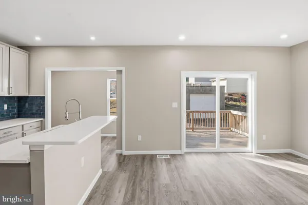 a view of a kitchen with a refrigerator cabinets and a wooden floor