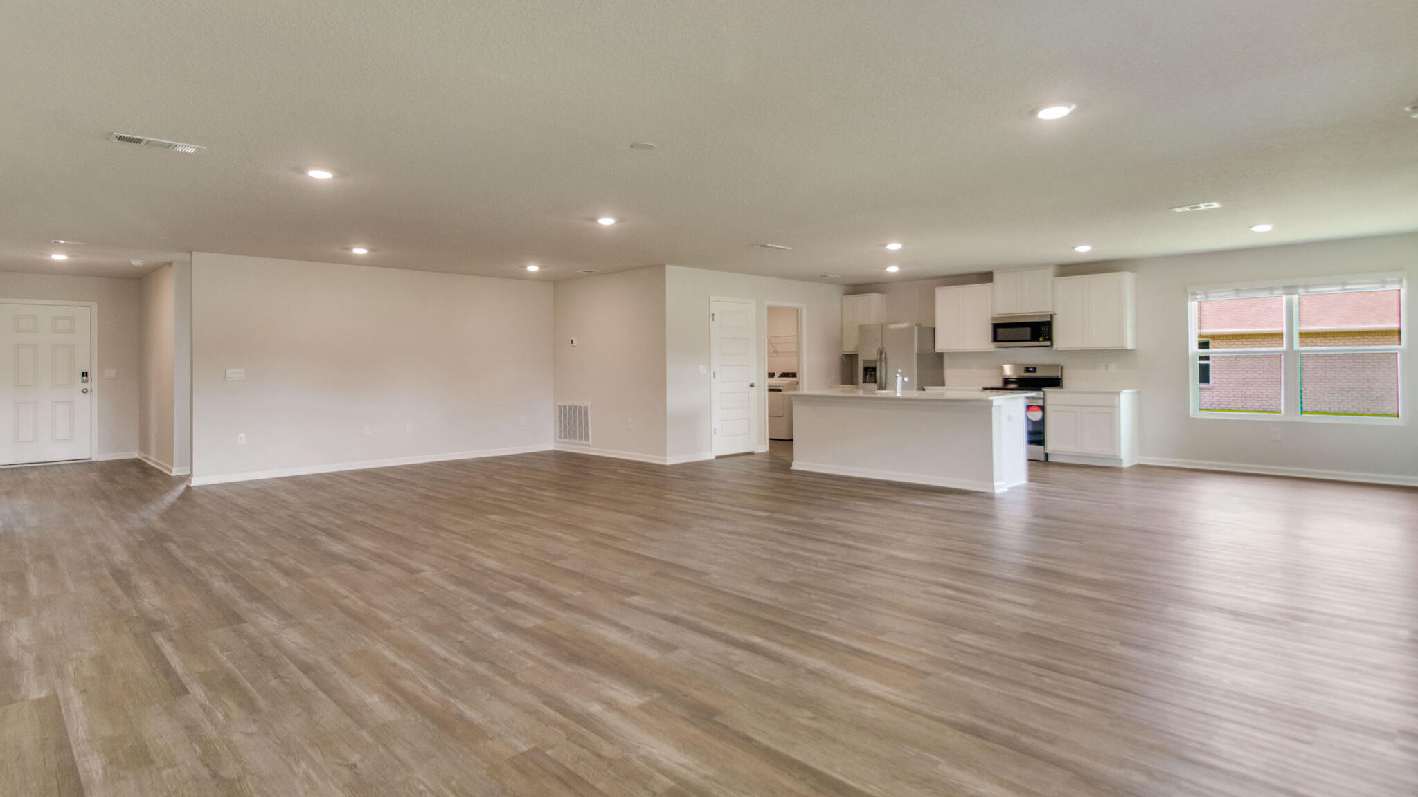 2512 Rutgers Road Crestview, FL 32536 - Photo 10 of 32 a view of a big room with wooden floor and windows