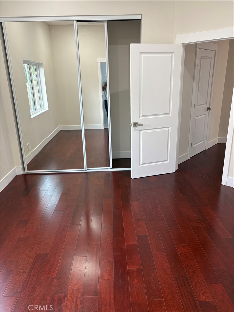 11862 Paseo Bonita Los Alamitos, CA 90720 - Photo 13 of 48 an empty room with wooden floor and windows