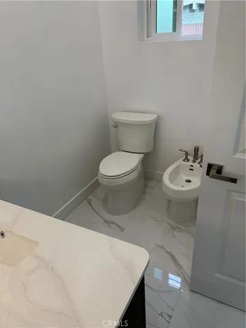 a bathroom with a toilet and a sink