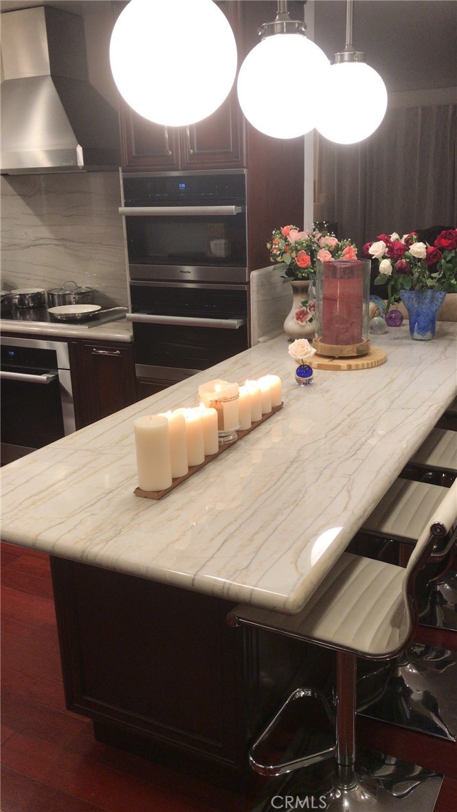 11862 Paseo Bonita Los Alamitos, CA 90720 - Photo 2 of 48 a kitchen with kitchen island a stove and a chandelier