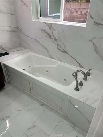 a view of a bathroom with wooden floor and a sink