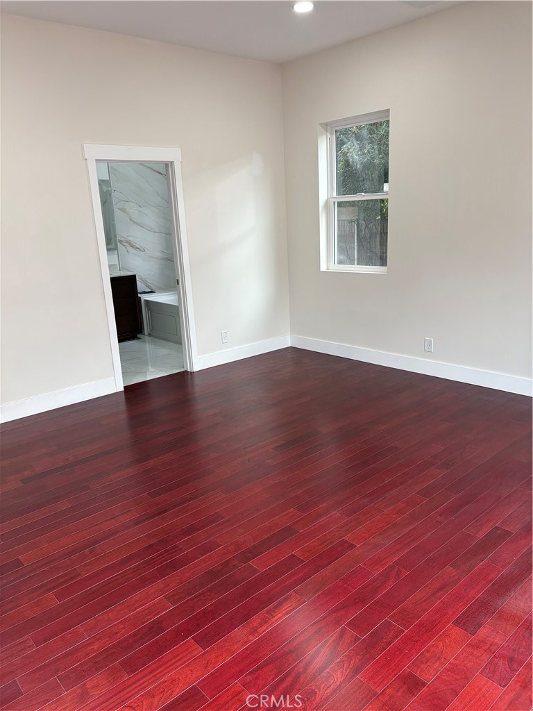11862 Paseo Bonita Los Alamitos, CA 90720 - Photo 27 of 48 a view of an empty room with wooden floor and a window