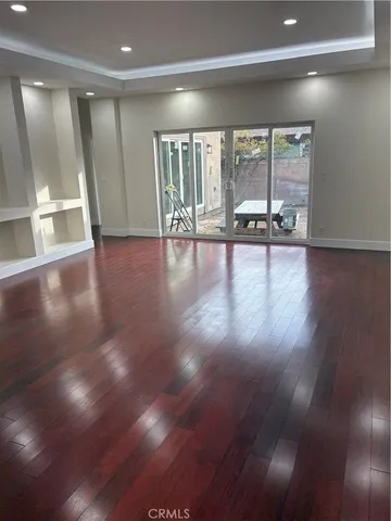 a dining room with furniture and wooden floor