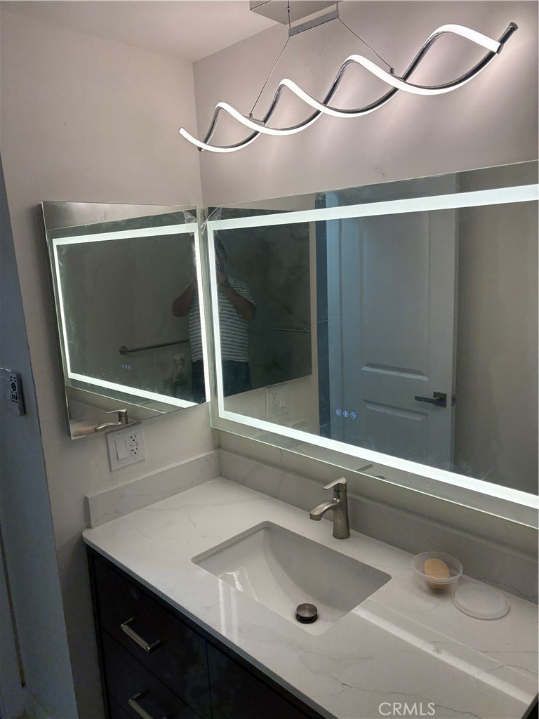 11862 Paseo Bonita Los Alamitos, CA 90720 - Photo 44 of 48 a bathroom with a sink and mirror