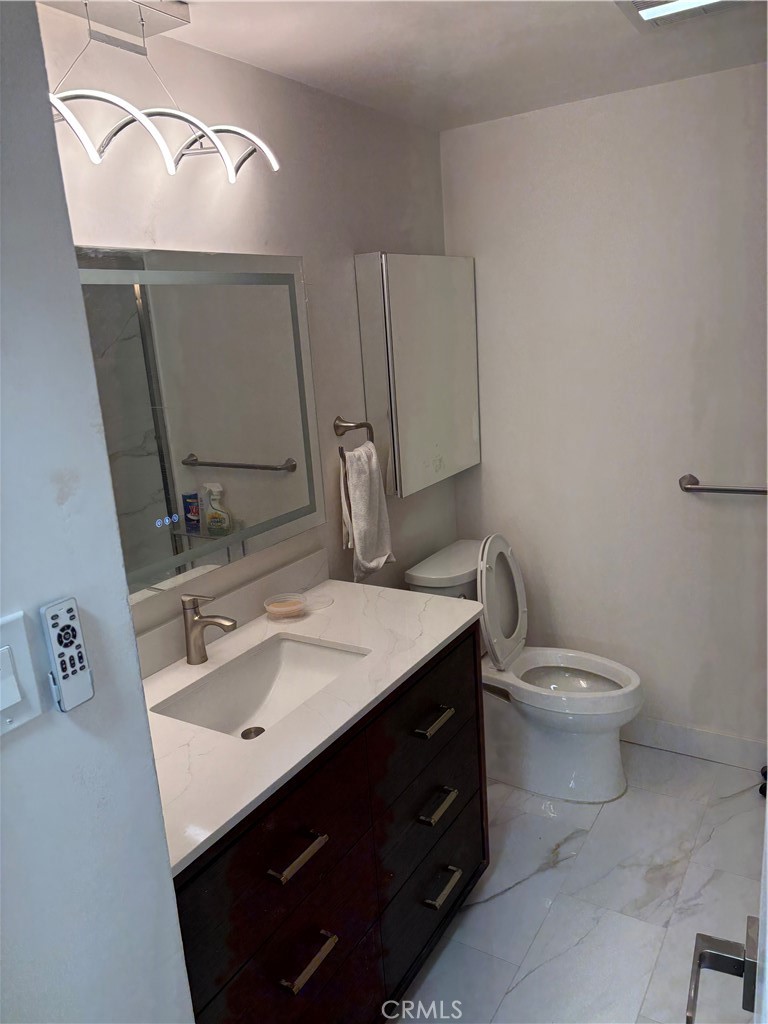 11862 Paseo Bonita Los Alamitos, CA 90720 - Photo 46 of 48 a bathroom with a sink toilet and mirror