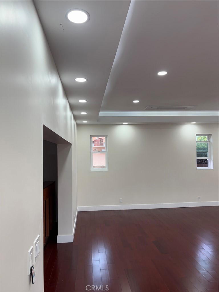 11862 Paseo Bonita Los Alamitos, CA 90720 - Photo 5 of 48 an empty room with wooden floor and windows