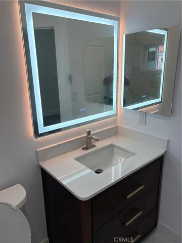 a bathroom with a sink vanity and a mirror