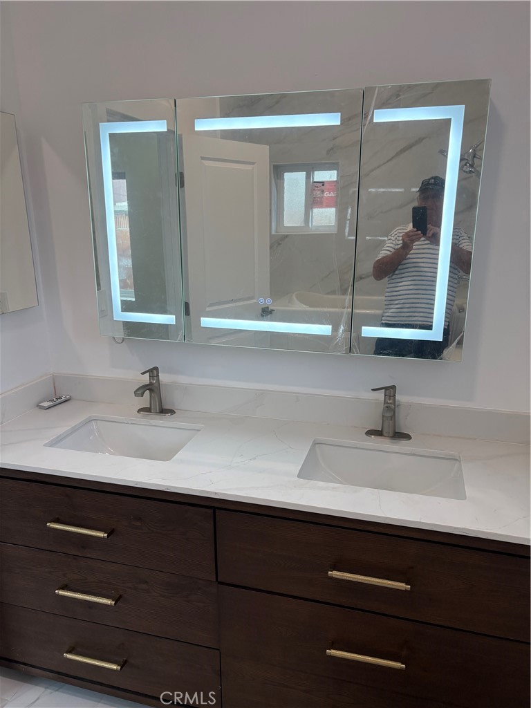 11862 Paseo Bonita Los Alamitos, CA 90720 - Photo 10 of 48 a bathroom with a sink and a mirror