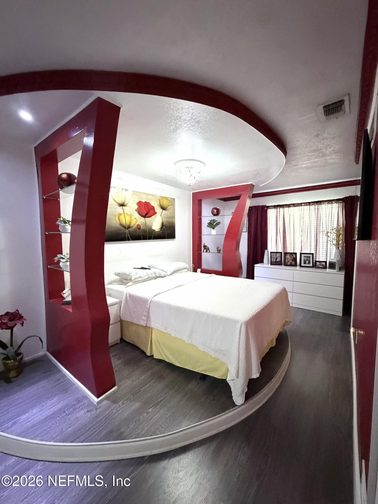 4127 Springwood Road Jacksonville, FL 32207 - Photo 24 of 63 a bedroom with a large bed and a mirror