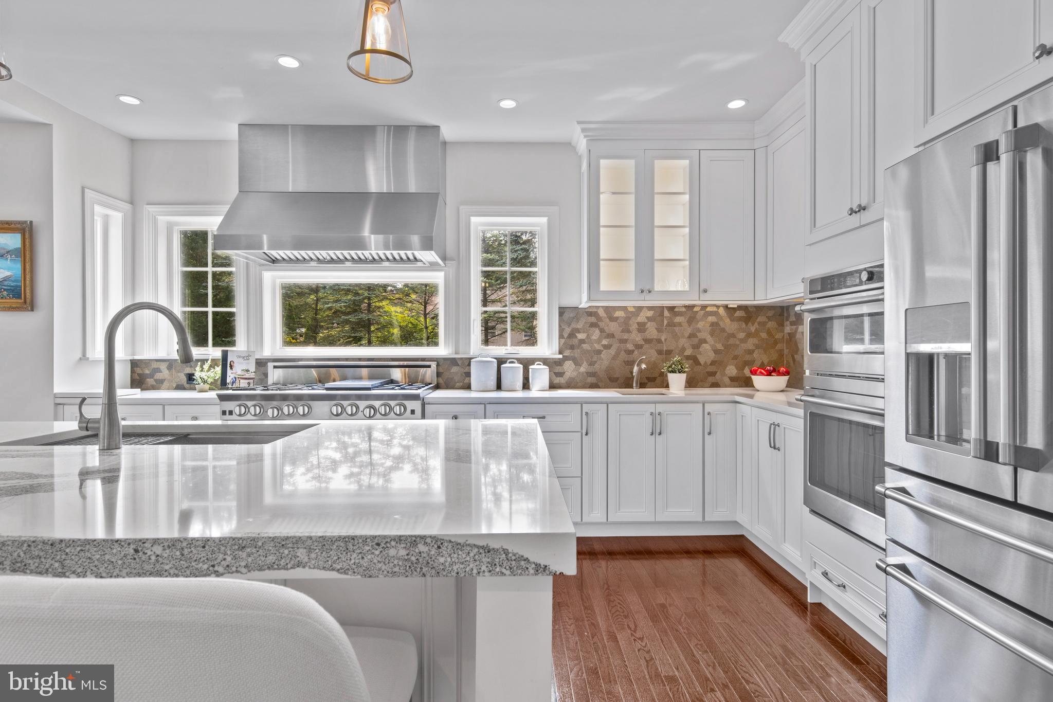 444 Conestoga Road Wayne, PA 19087 - Photo 20 of 82 a kitchen with stainless steel appliances granite countertop a sink and wooden cabinets