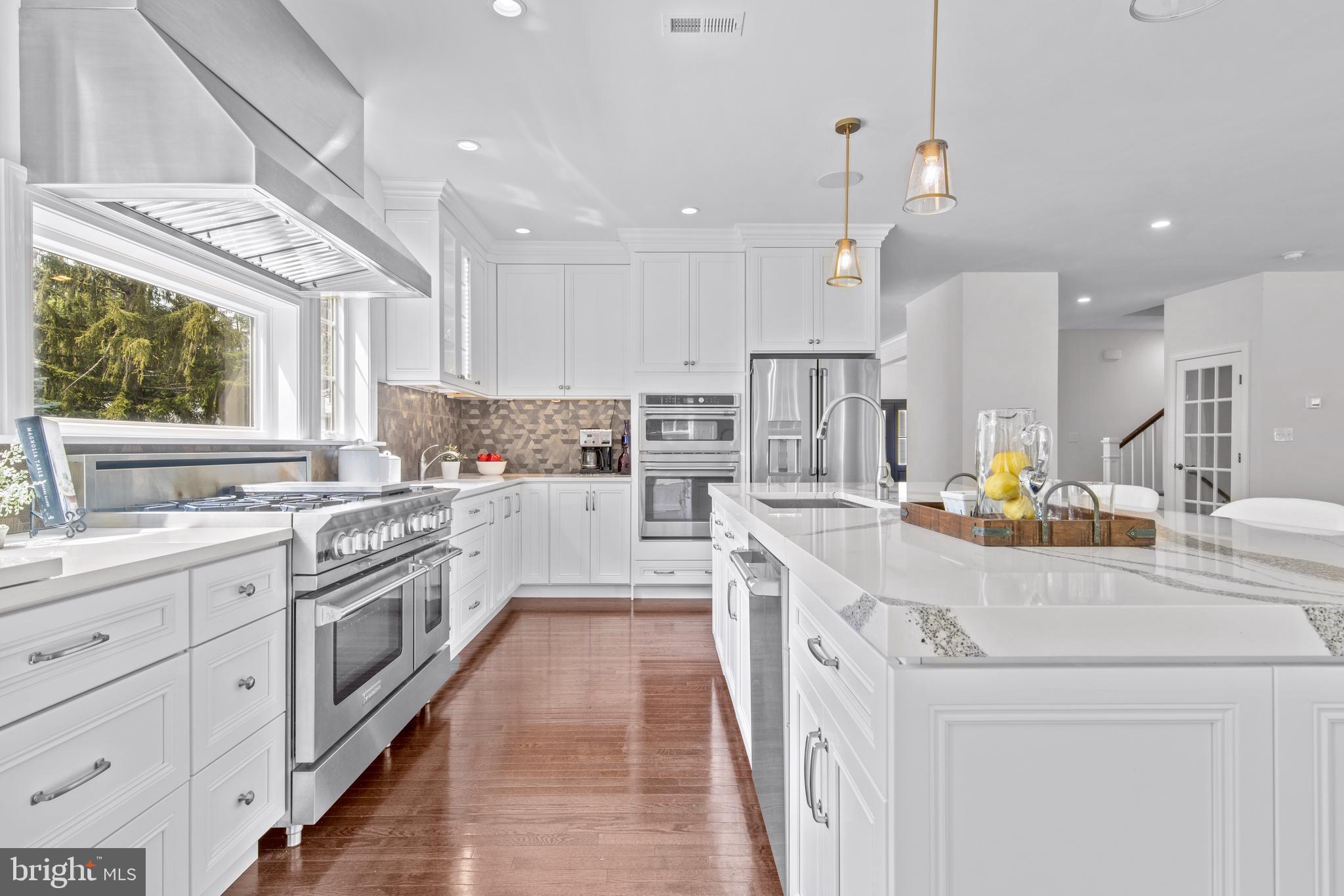 444 Conestoga Road Wayne, PA 19087 - Photo 23 of 82 a kitchen with kitchen island granite countertop lots of white stainless steel appliances cabinets and a sink