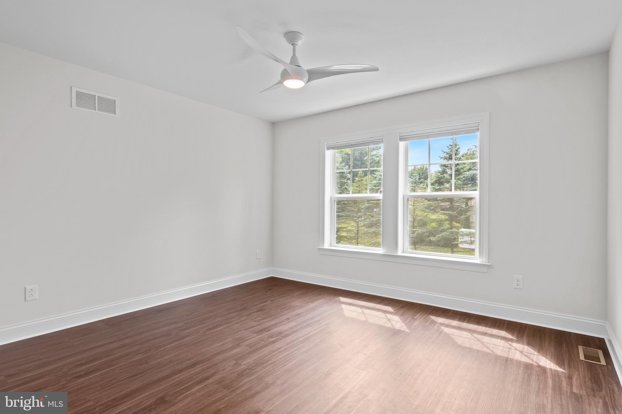 444 Conestoga Road Wayne, PA 19087 - Photo 50 of 82 an empty room with wooden floor and windows