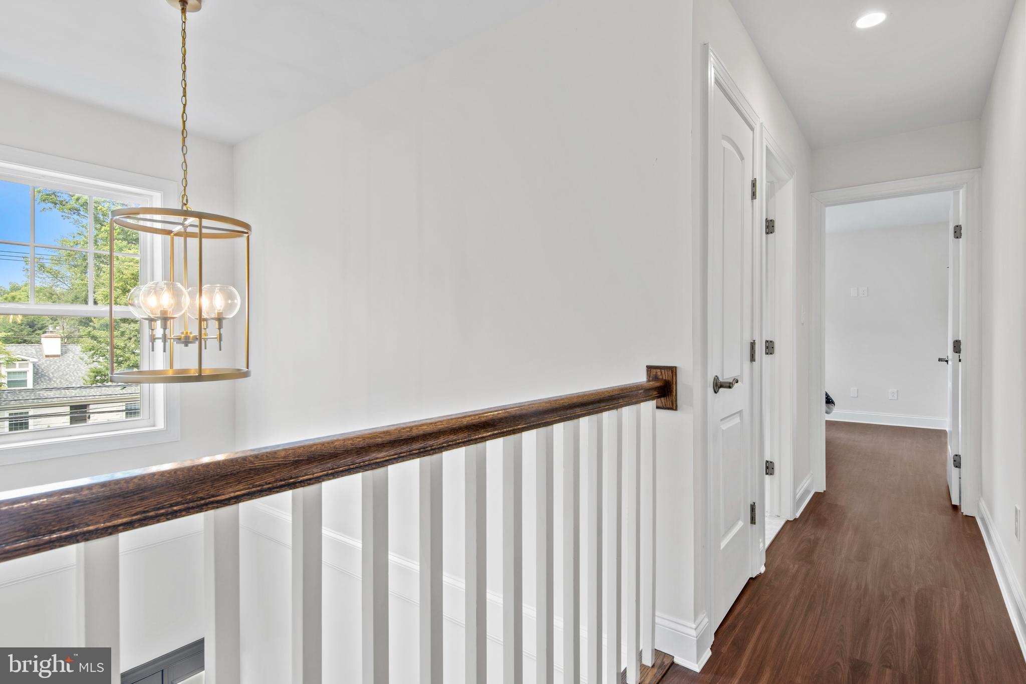 444 Conestoga Road Wayne, PA 19087 - Photo 56 of 82 a view of a hallway with wooden floor and staircase