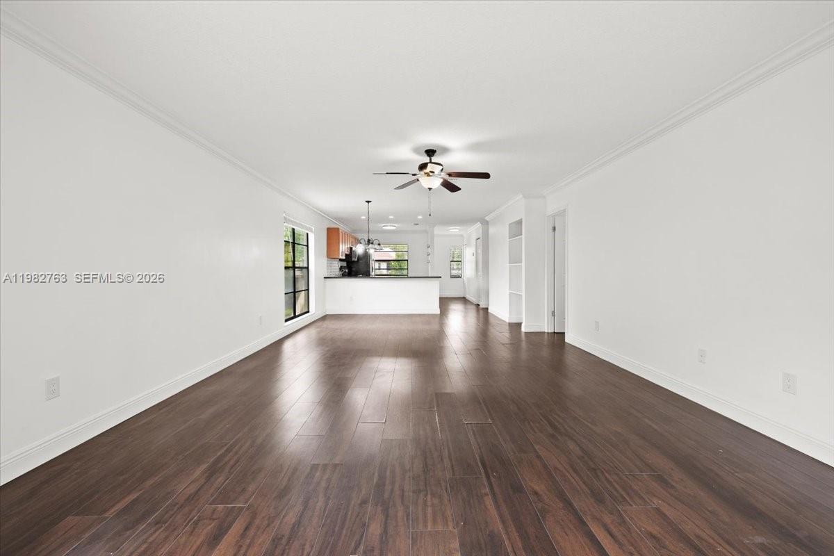 7944 Eastlake Drive, Unit D Boca Raton, FL 33433 - Photo 9 of 29 a view of a livingroom with wooden floor and a ceiling fan