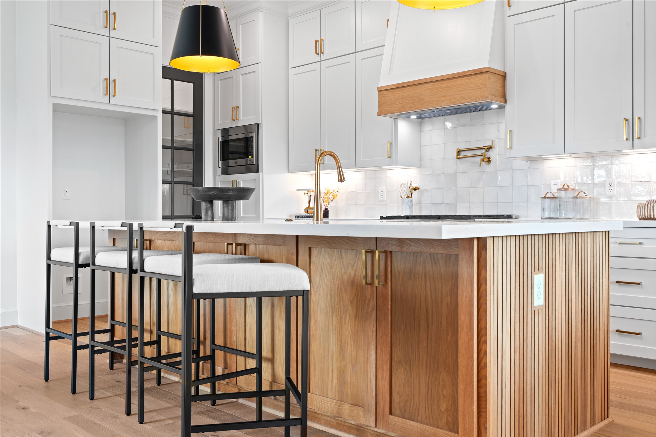 1614 Ojeman Road, Unit J Houston, TX 77055 - Photo 15 of 50 Custom cabinetry beneath the island offers thoughtful extra storage, ideal for organizing entertaining pieces or setting up dedicated areas for guests.