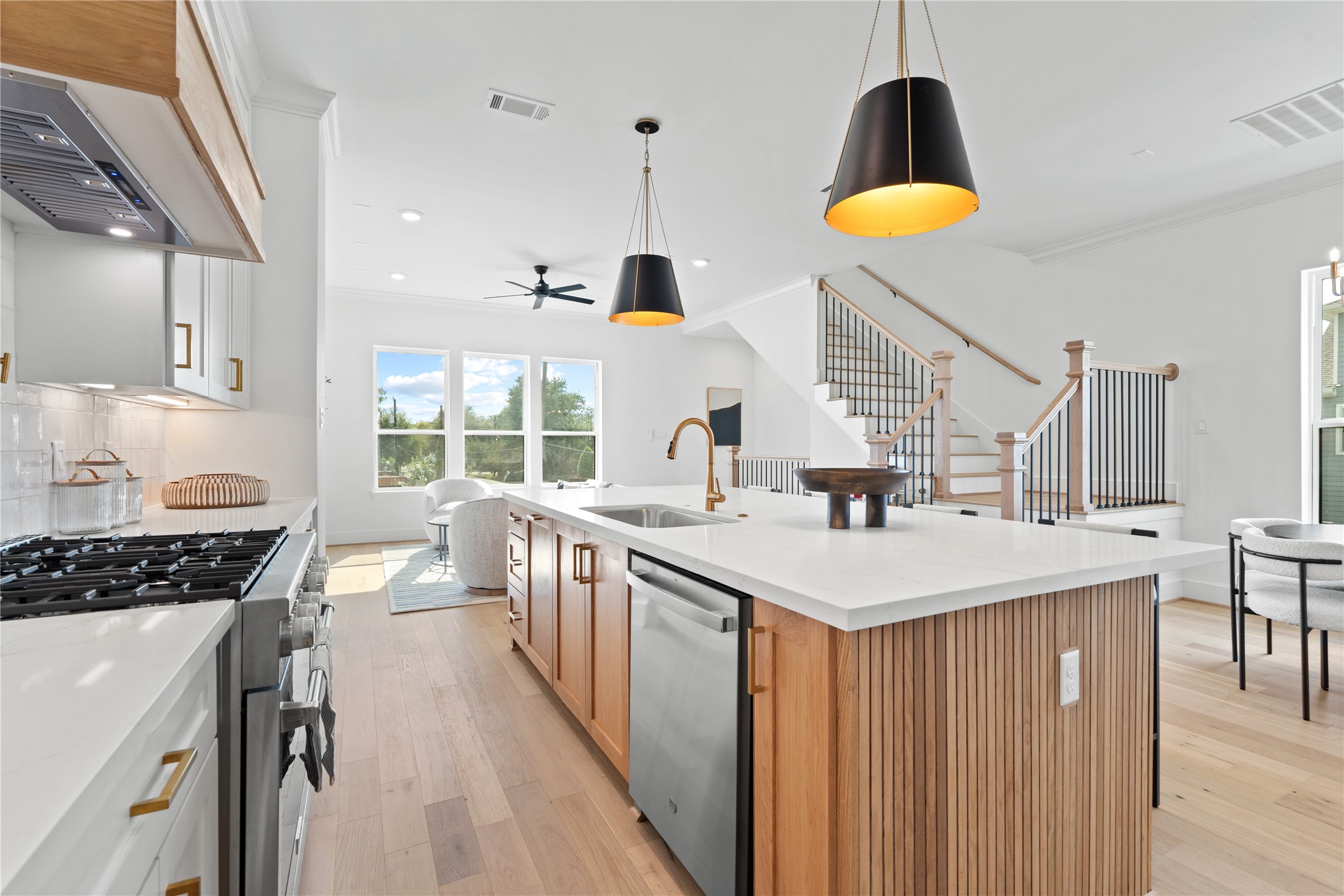 1614 Ojeman Road, Unit J Houston, TX 77055 - Photo 18 of 50 A large island with a built-in sink accented by premium Moen fixtures, sleek stainless steel appliances, and a seamless flow into the living area - perfect for both everyday living and entertaining.