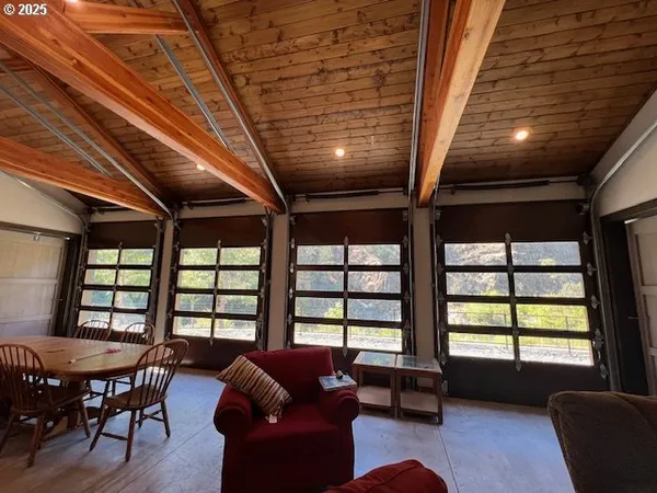 a living room with furniture and a floor to ceiling window