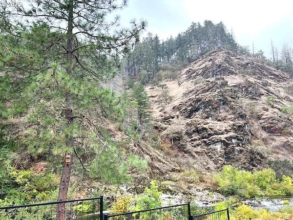 a view of a house with a wooden deck and furniture