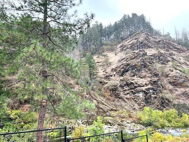 a view of a house with a wooden deck and furniture