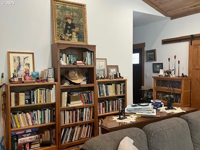 a living room with furniture and a book shelf