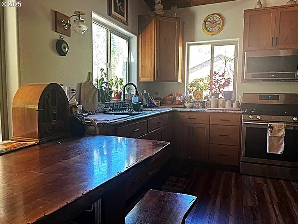 a kitchen with sink cabinets and wooden floor