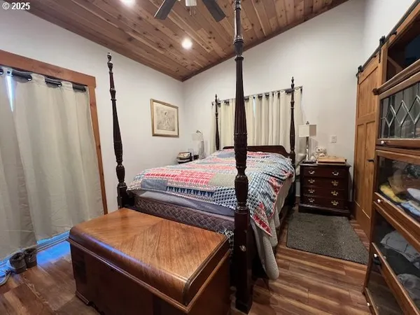 a bedroom with a bed next to a window