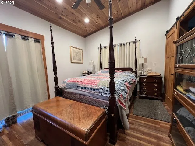 a bedroom with a bed next to a window