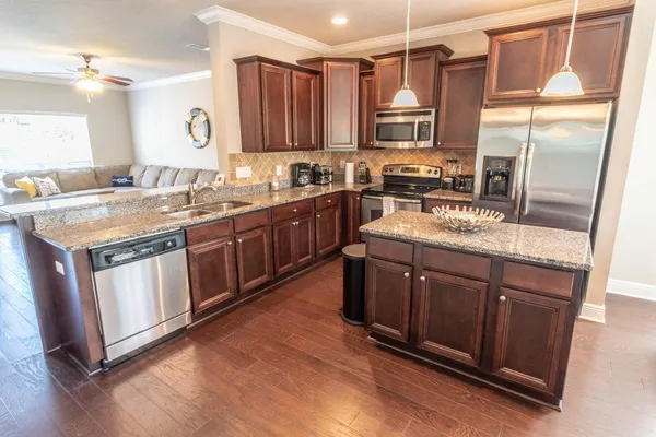 a kitchen with a stove window and cabinets