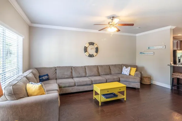 a living room with furniture and a chandelier