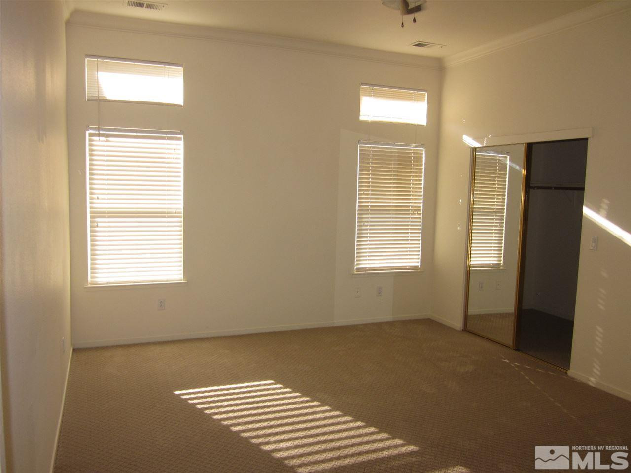 9380 Oakley Court Reno, NV 89521 - Photo 8 of 12 a view of wooden floor and windows in a room