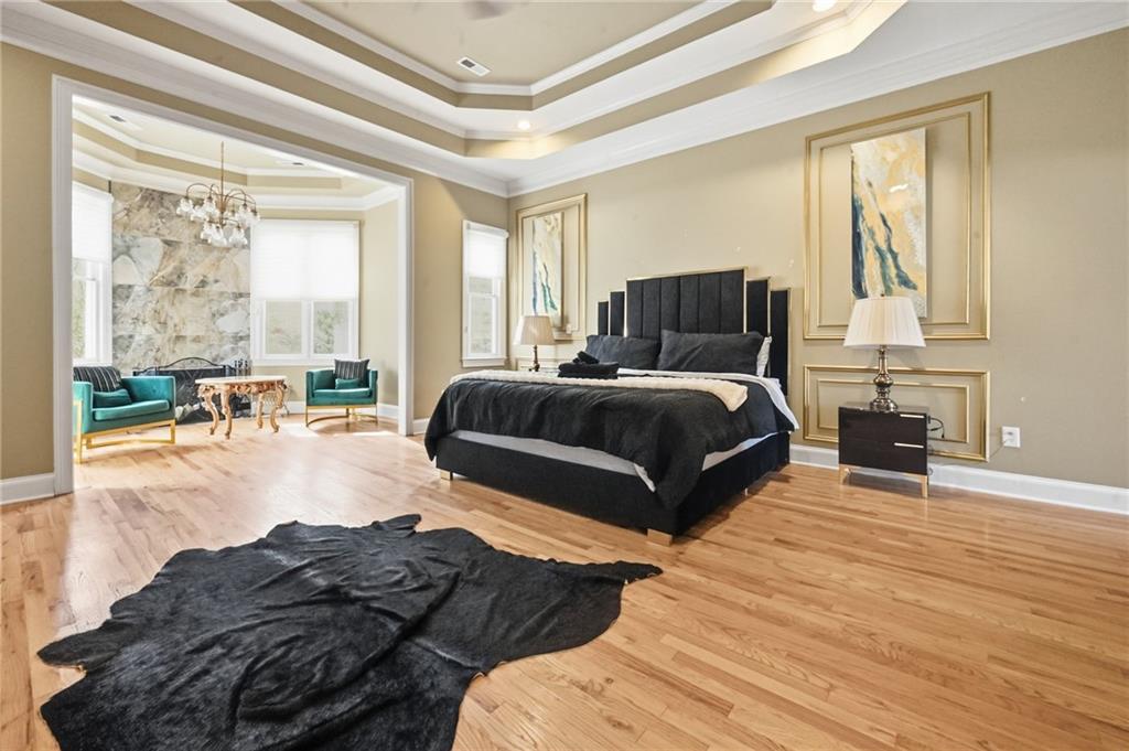 4670 Hamden Forest Drive Southwest Atlanta, GA 30331 - Photo 14 of 68 a spacious bedroom with a bed a couch and large window with outer view