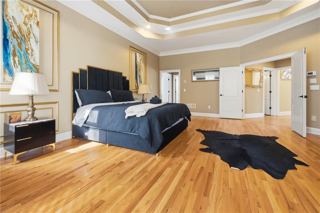 4670 Hamden Forest Drive Southwest Atlanta, GA 30331 - Photo 16 of 68 a spacious bedroom with a bed and wooden floor